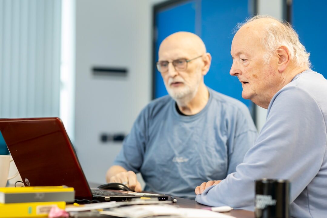 Seniors learning to use tablets and computers in an education workshop
